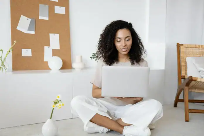 Woman using laptop to check NAIC Database – insurance lookup illustration