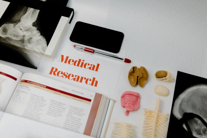 Clinical Drug Experience Knowledgebase illustration with medical research tools and anatomical models