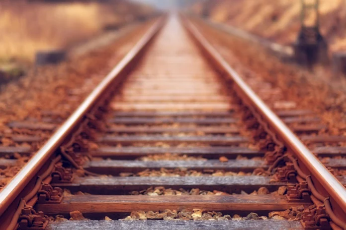 Straight railroad tracks disappearing into the distance, illustrating the scope and purpose of the FRA Safety Database.