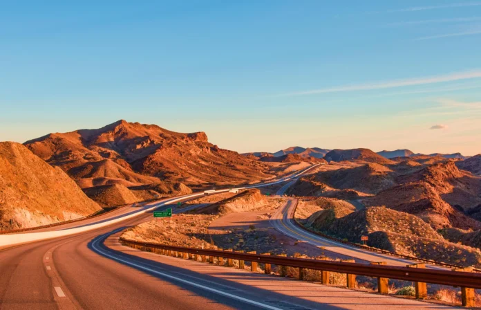 Nevada Business Entity Search – a desert highway through Nevada mountains at sunset, symbolizing access and transparency in Nevada’s business landscape.