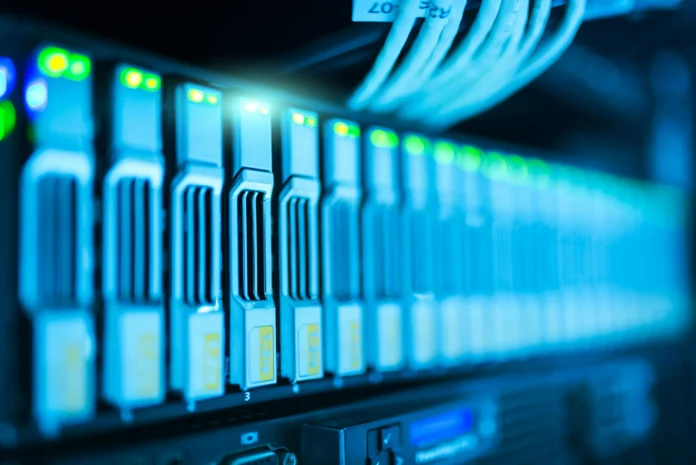 Global Data Center Database illustration showing server racks with active network cables and storage drives inside a modern data center.
