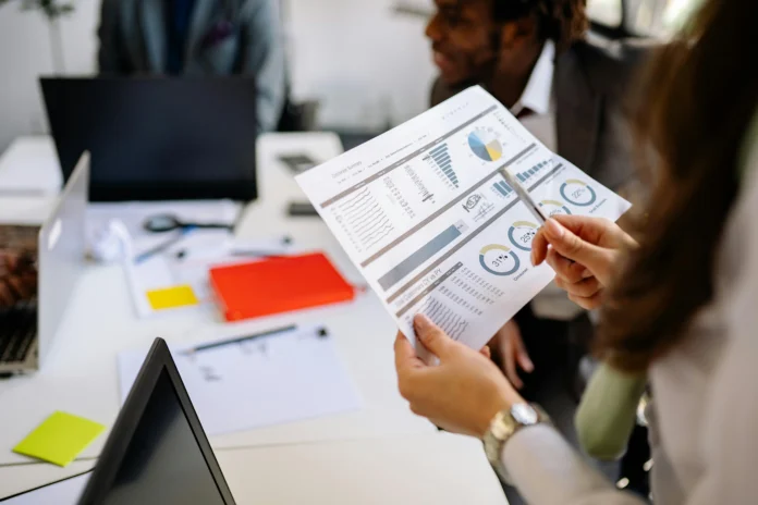 Business professionals analyzing legal and financial charts, representing use cases of the New Mexico Business Entity Search database.