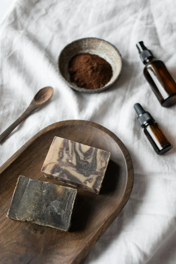 Plastic Free Database natural materials — handmade soap bars, glass bottles, and organic ingredients representing sustainable design alternatives to plastic.